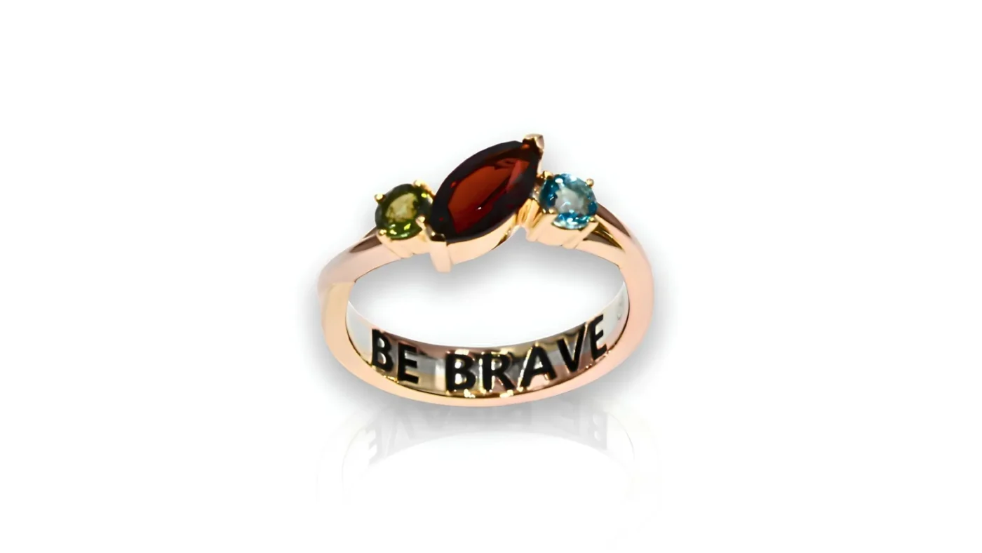 Custom BE BRAVE ring with mixed gold bands and gemstones in Paralympic colours