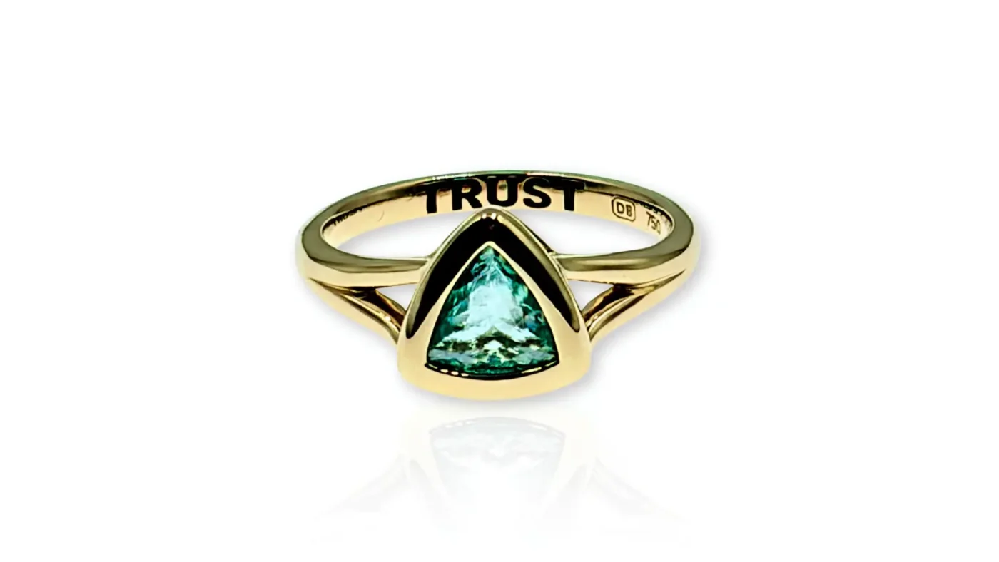 Sharni Layton’s custom gold TRUST ring with a triangular Paraiba tourmaline